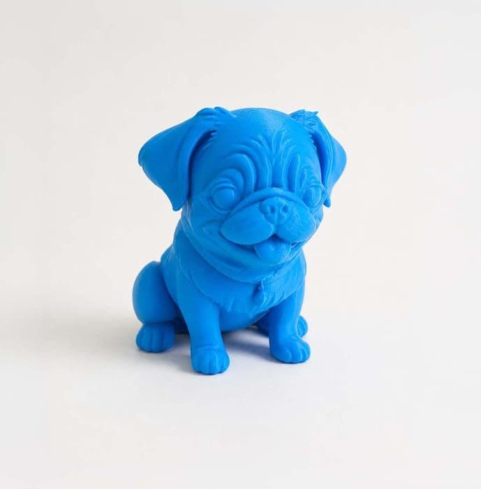 The blue 3D printed Pug figurine turned slightly to one side